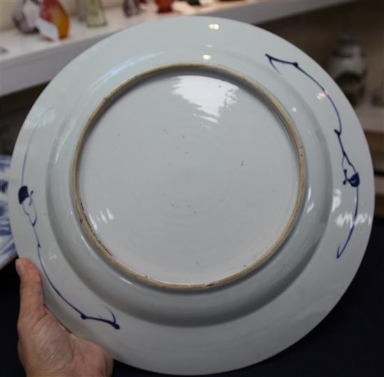 Three matching Chinese blue and white chargers, decorated lake scenes with pavilions and mountains,